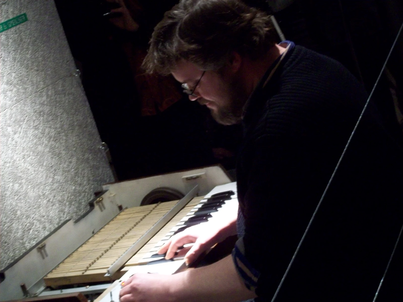 A musician playing a Mellotron M400, with the tape mechanism visible